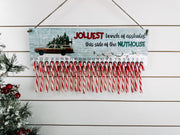Funny wooden Christmas countdown with 24 candy cane holders