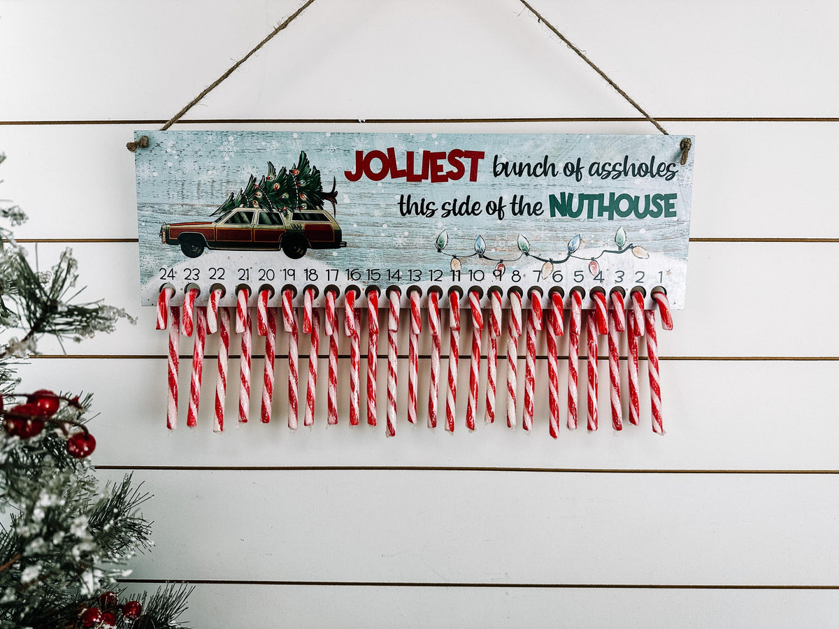 Funny wooden Christmas countdown with 24 candy cane holders