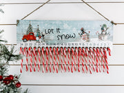 Wooden Christmas countdown with red truck snowmen and 24 candy canes