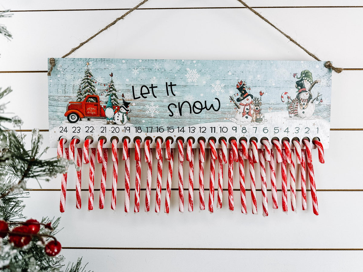 Wooden Christmas countdown with red truck snowmen and 24 candy canes